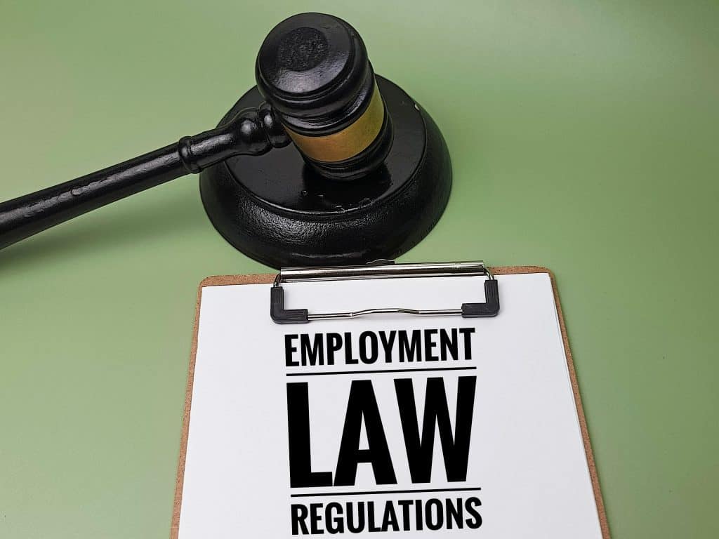 Gavel and clipboard with "Employment Law Regulations" for employment rights changes in 2025.